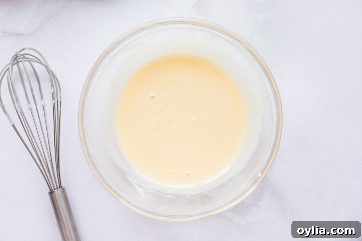 Sour cream glaze mixed in a bowl, ready to be applied