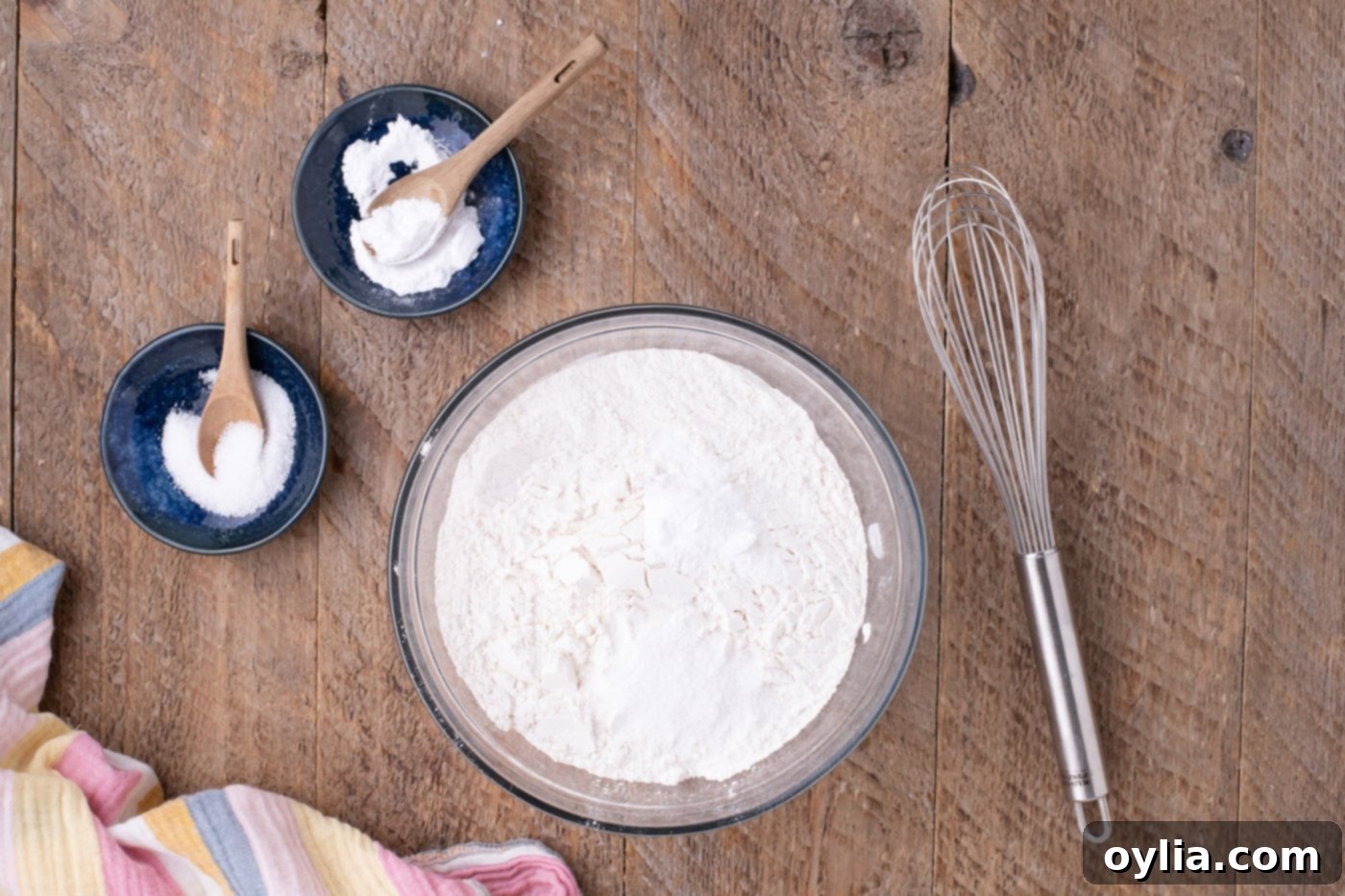 Dry ingredients for cookies in a bowl, showing flour, baking soda, and salt mixed together.