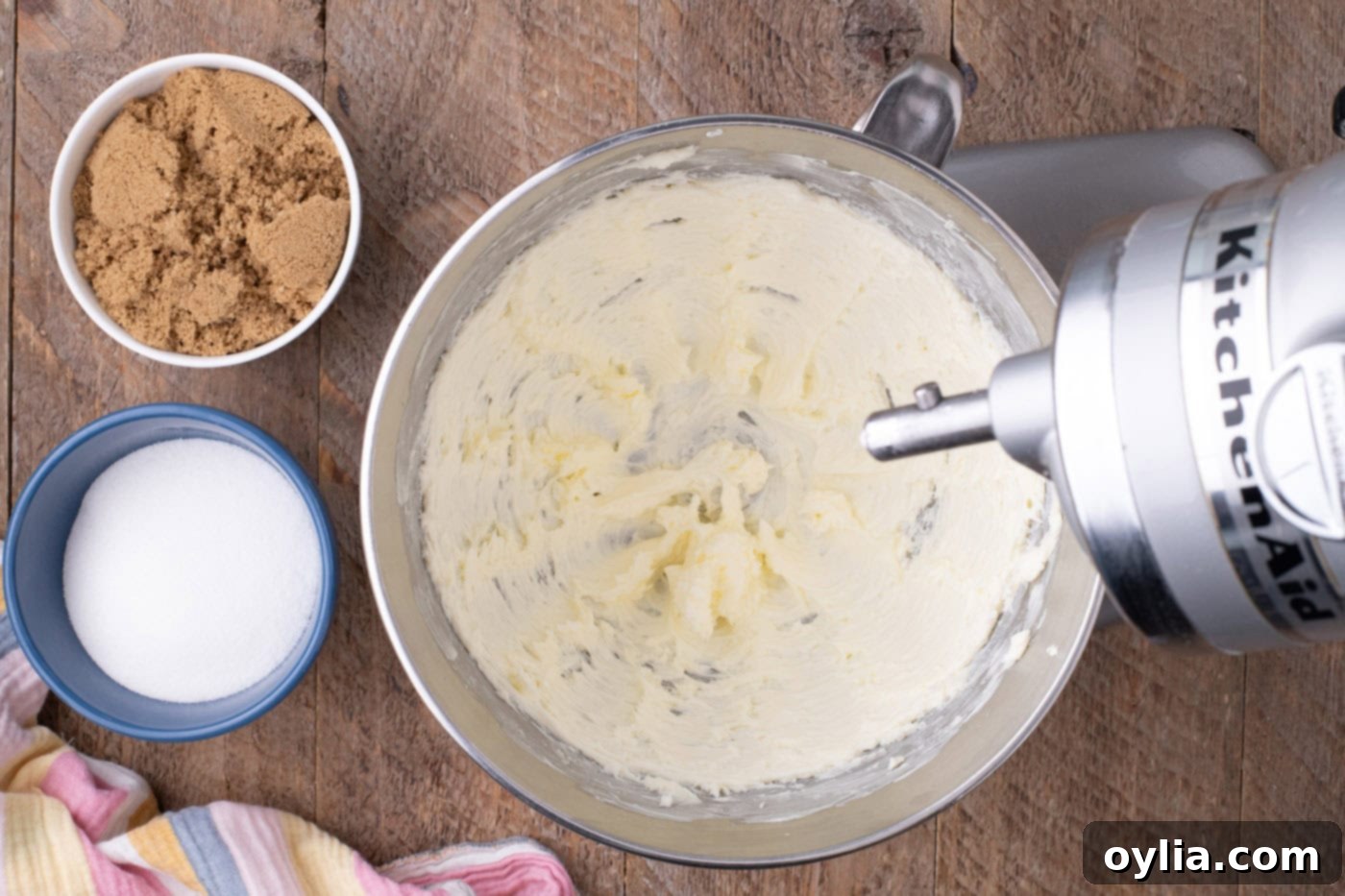 Butter being beaten in a stand mixer bowl, showing a light and fluffy texture.