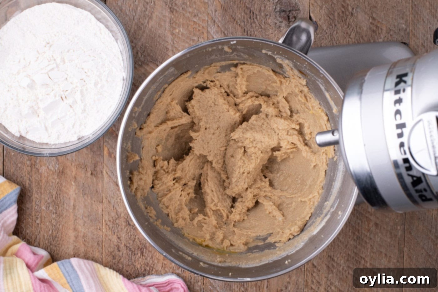 Butter and sugar mixture in a stand mixer with eggs and vanilla added.