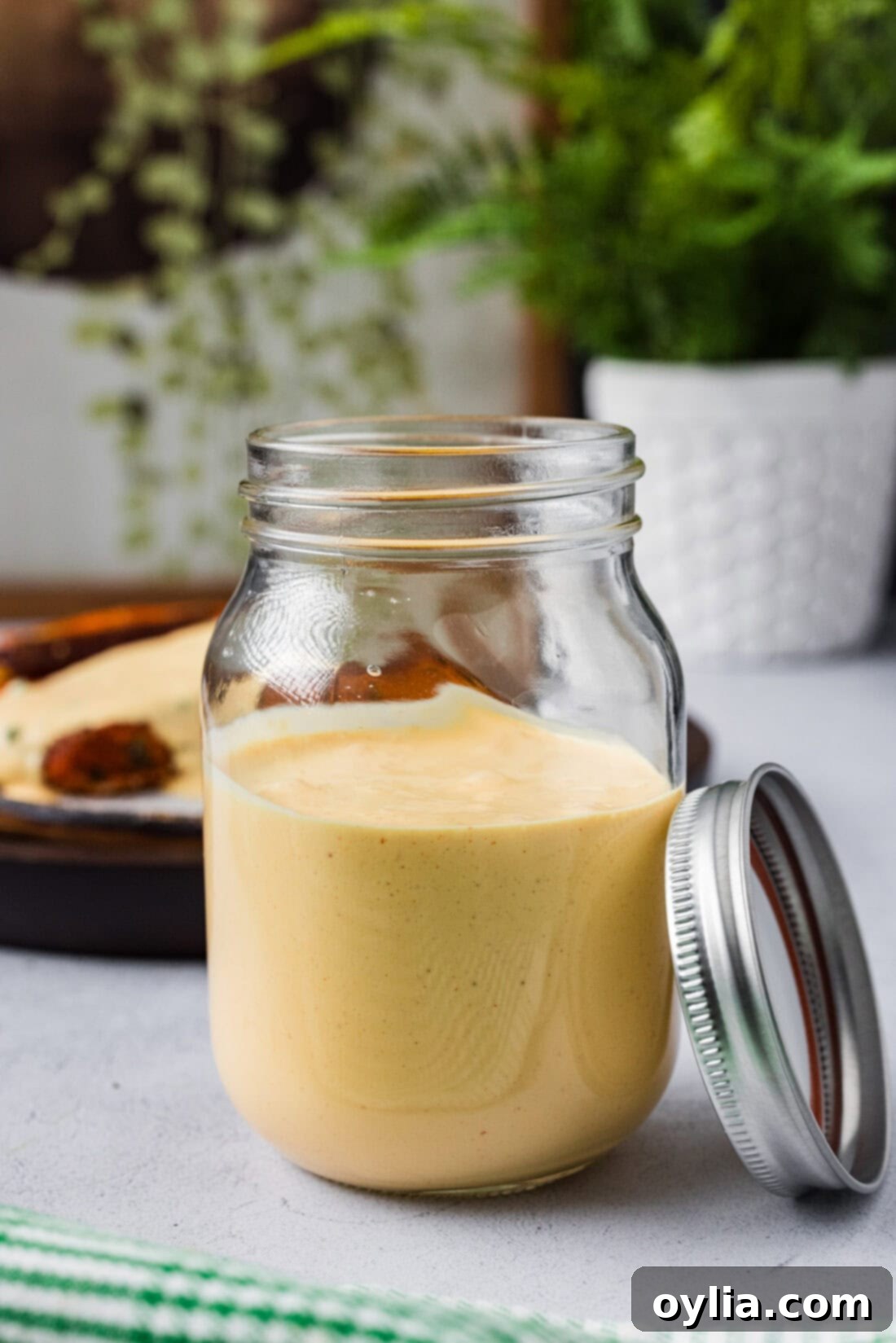 Freshly prepared homemade Remoulade Sauce stored in a clear glass jar, showcasing its smooth and inviting texture