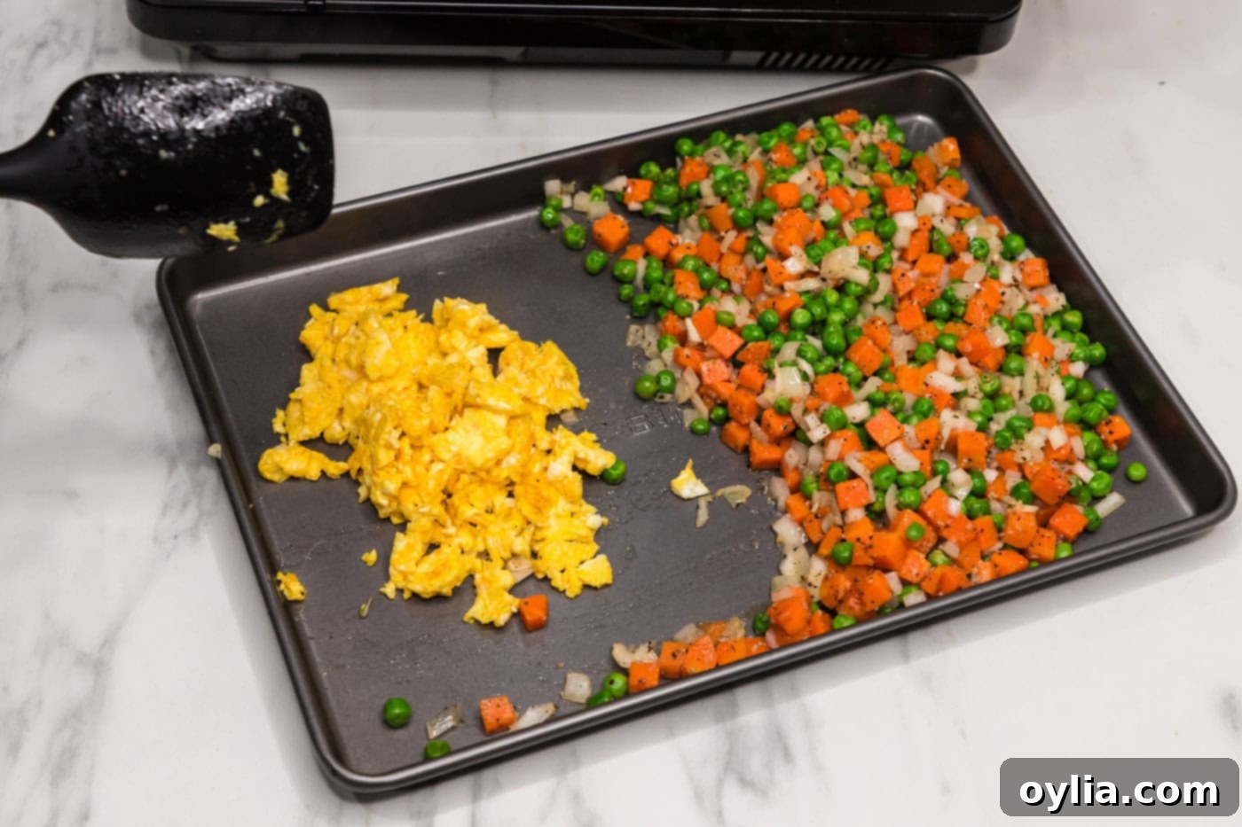 scrambled eggs and stir fried vegetables on a pan