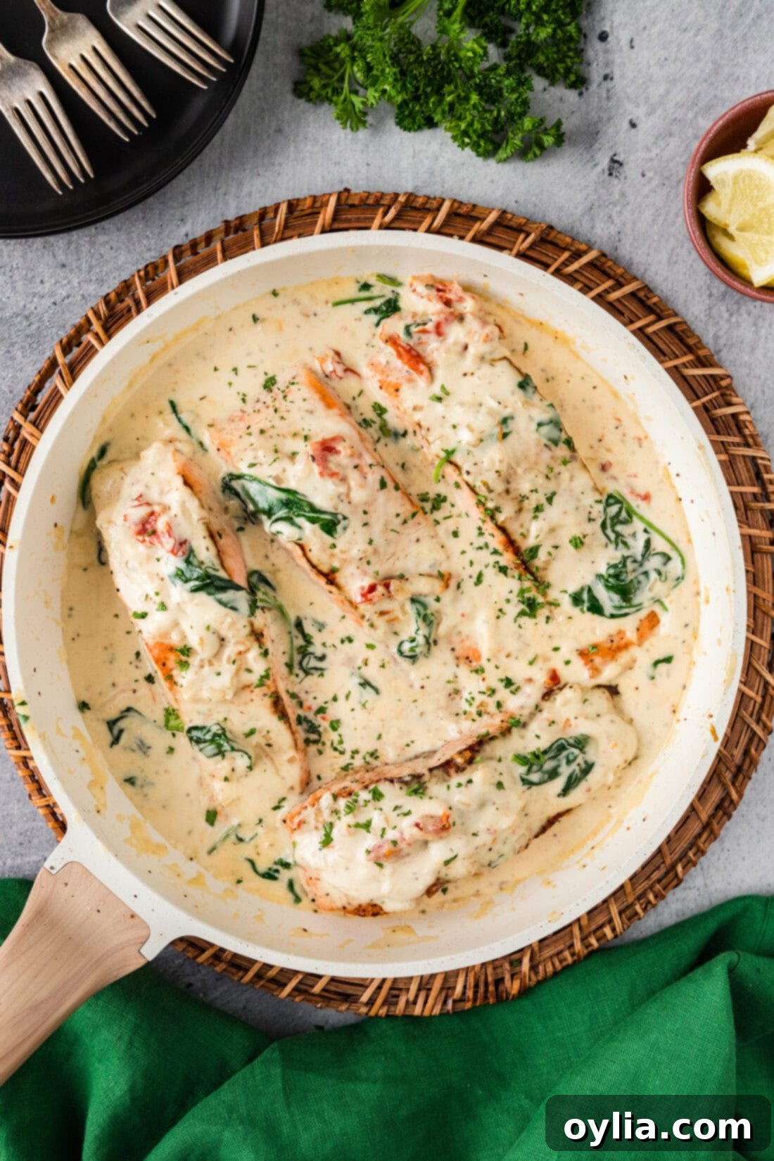 A vibrant skillet of Tuscan Salmon, rich with creamy sauce, sun-dried tomatoes, and spinach.