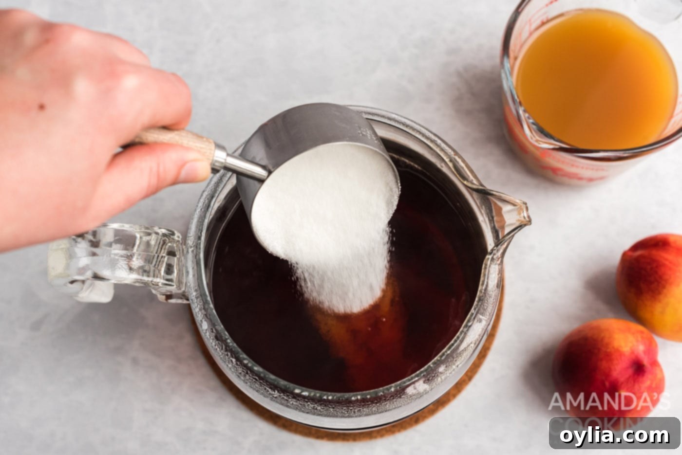 Stirring granulated sugar into the cold brew tea