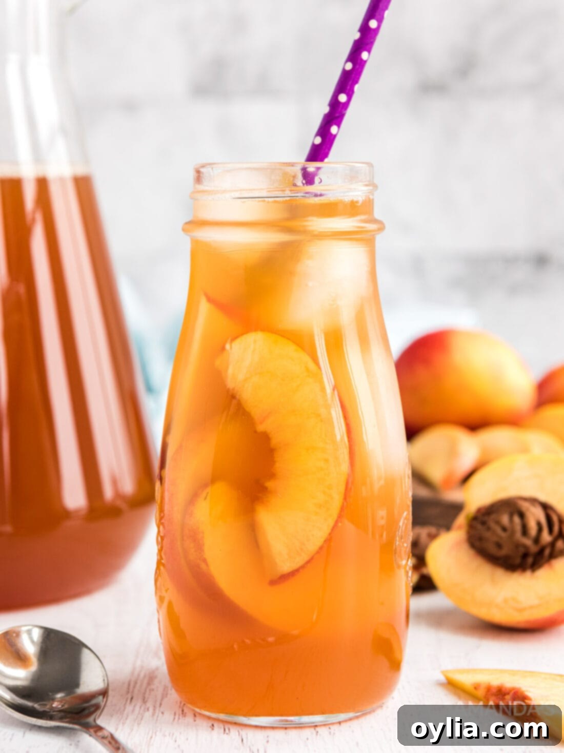 Bottle of homemade cold brew peach iced tea on a wooden surface