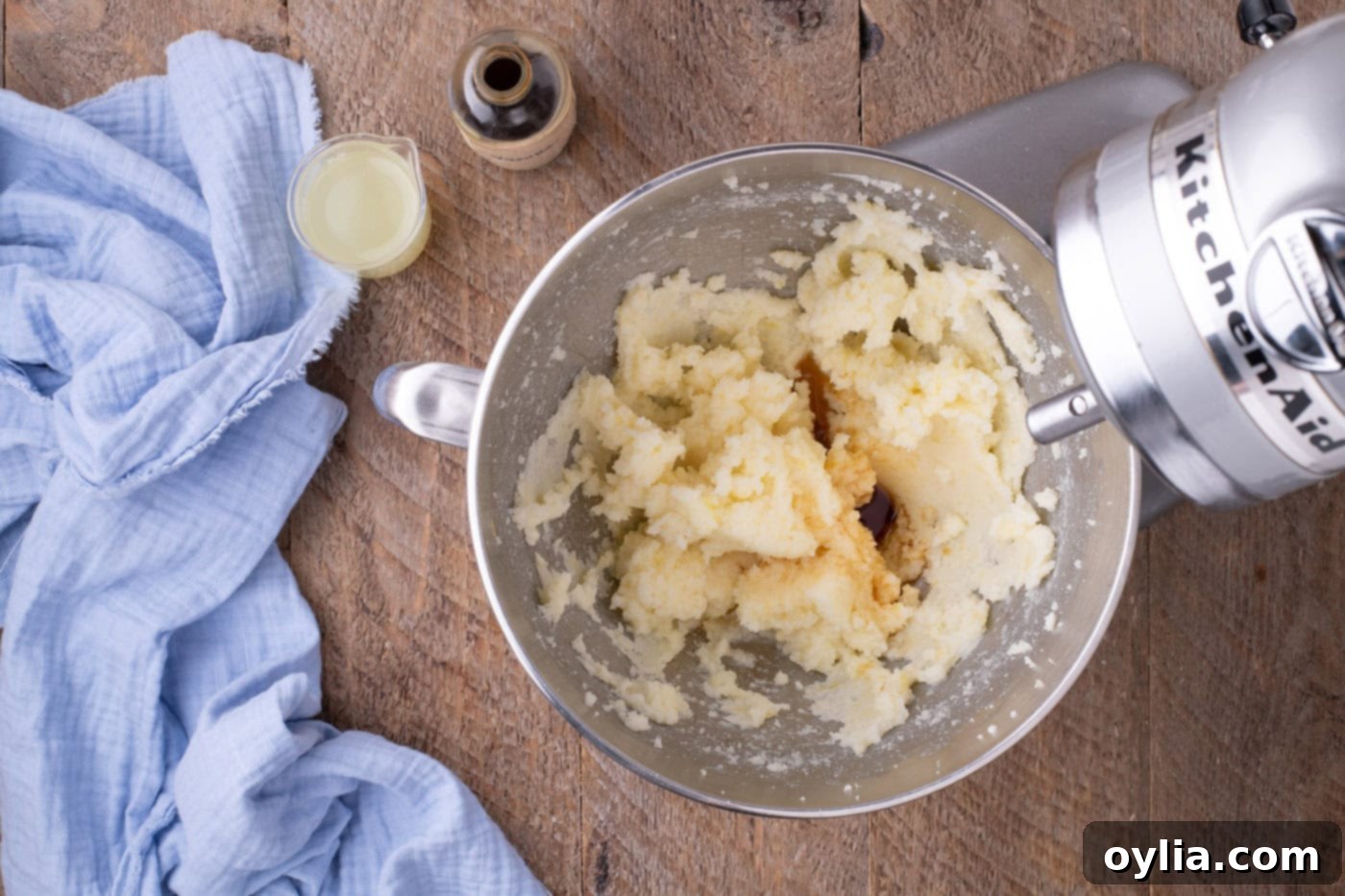 Butter and sugar mixture in a stand mixer bowl after adding vanilla extract
