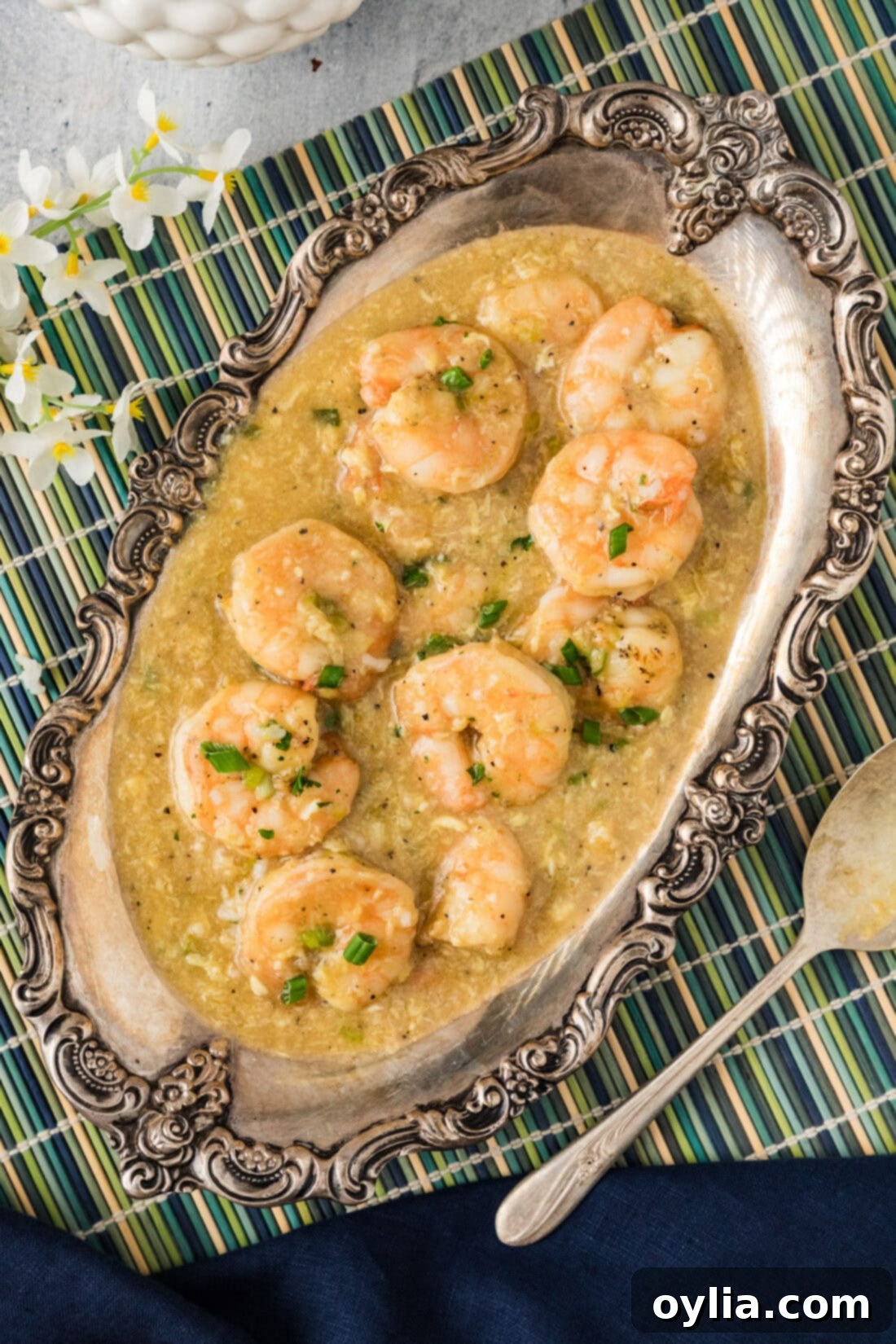 A large platter of freshly made Shrimp with Lobster Sauce, garnished with green onions and ready to be served
