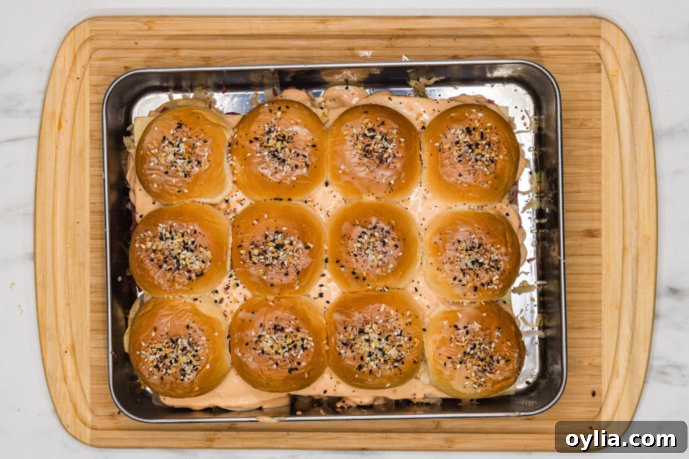 Reuben sliders with buttered tops generously sprinkled with Everything Bagel seasoning