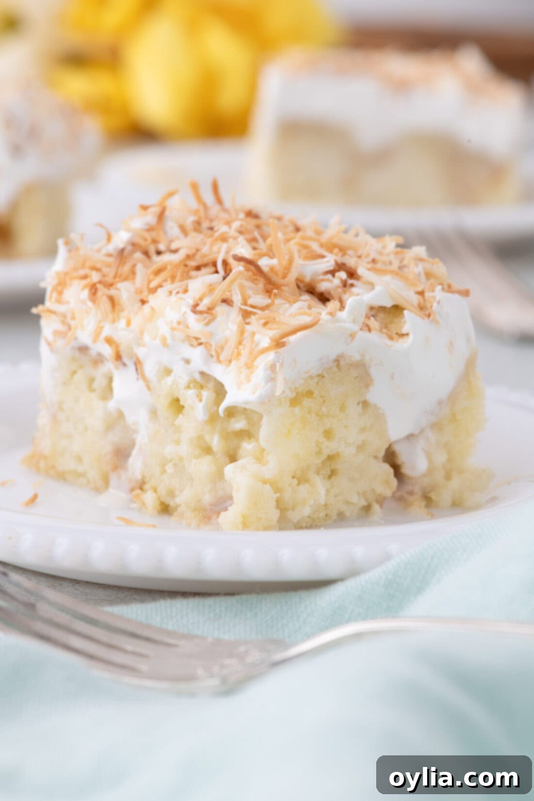 Slice of Coconut Poke Cake on a plate