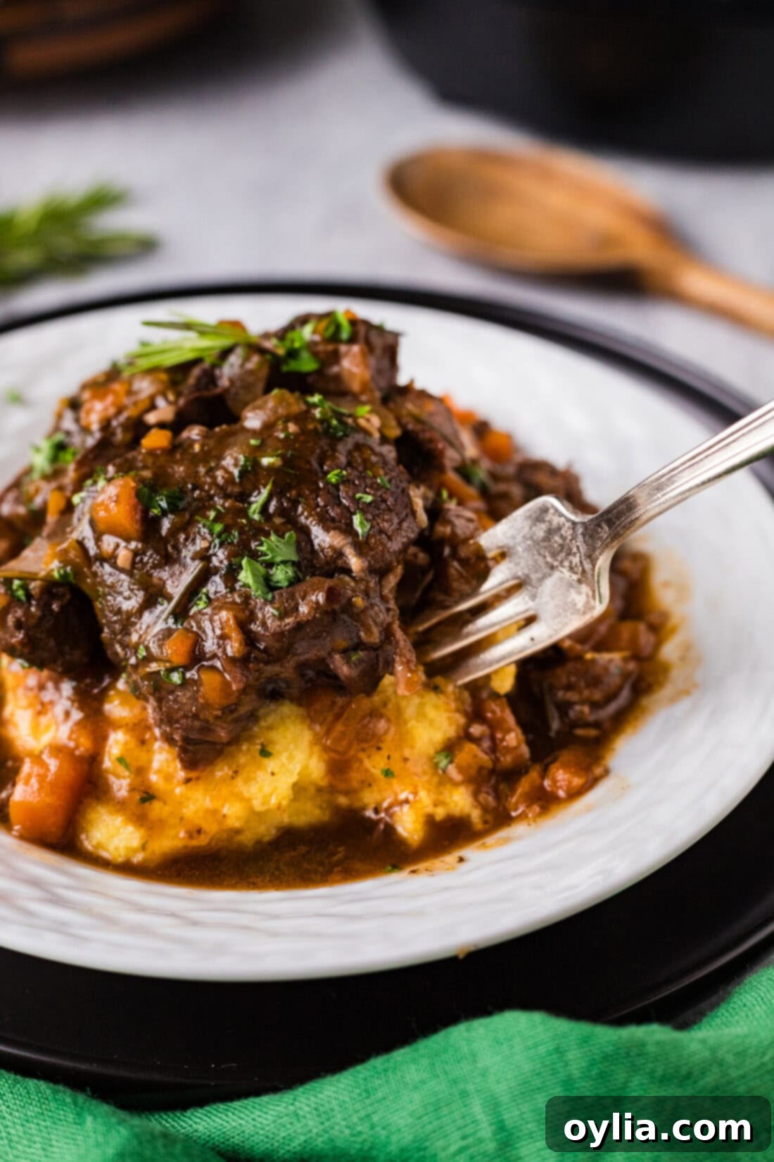 Close-up photo of a fork effortlessly going into tender Instant Pot Beef Shanks, showcasing its perfect texture.