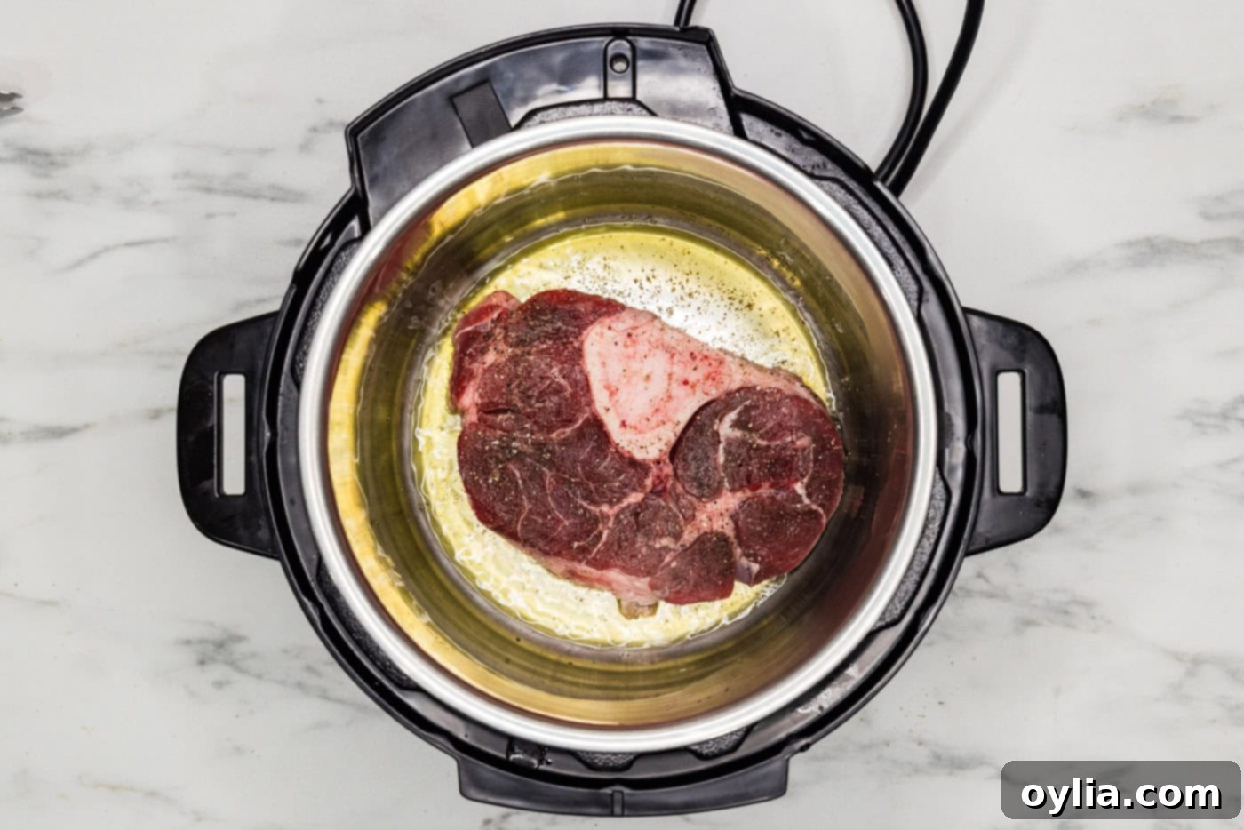 Beef shank browning in the Instant Pot, developing a flavorful crust.