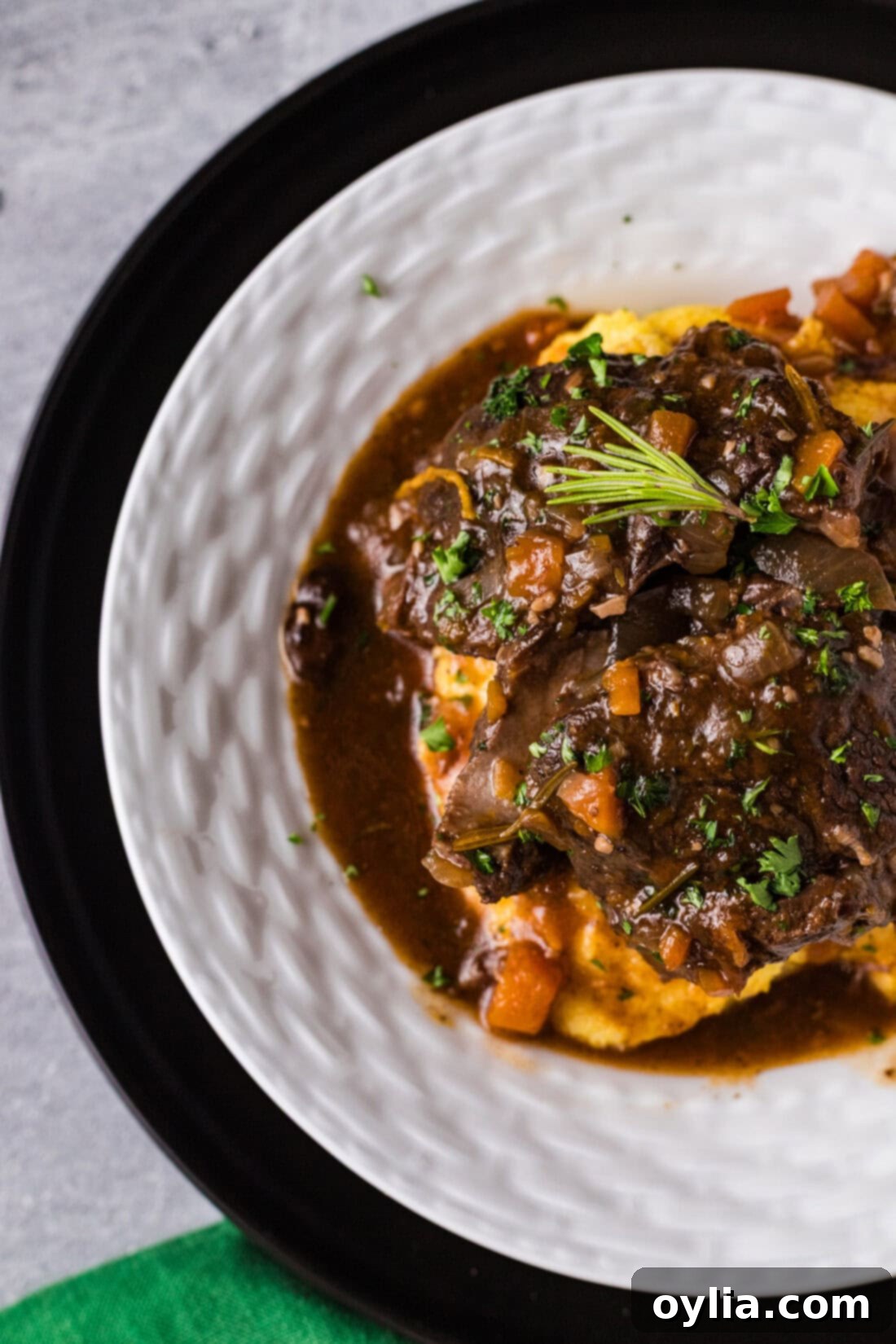 Close-up photo of a plated Instant Pot Beef Shank, showcasing the rich gravy and tender meat.
