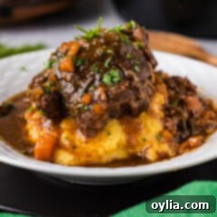 Close up photo of Instant Pot Beef Shanks onto of mashed potatoes
