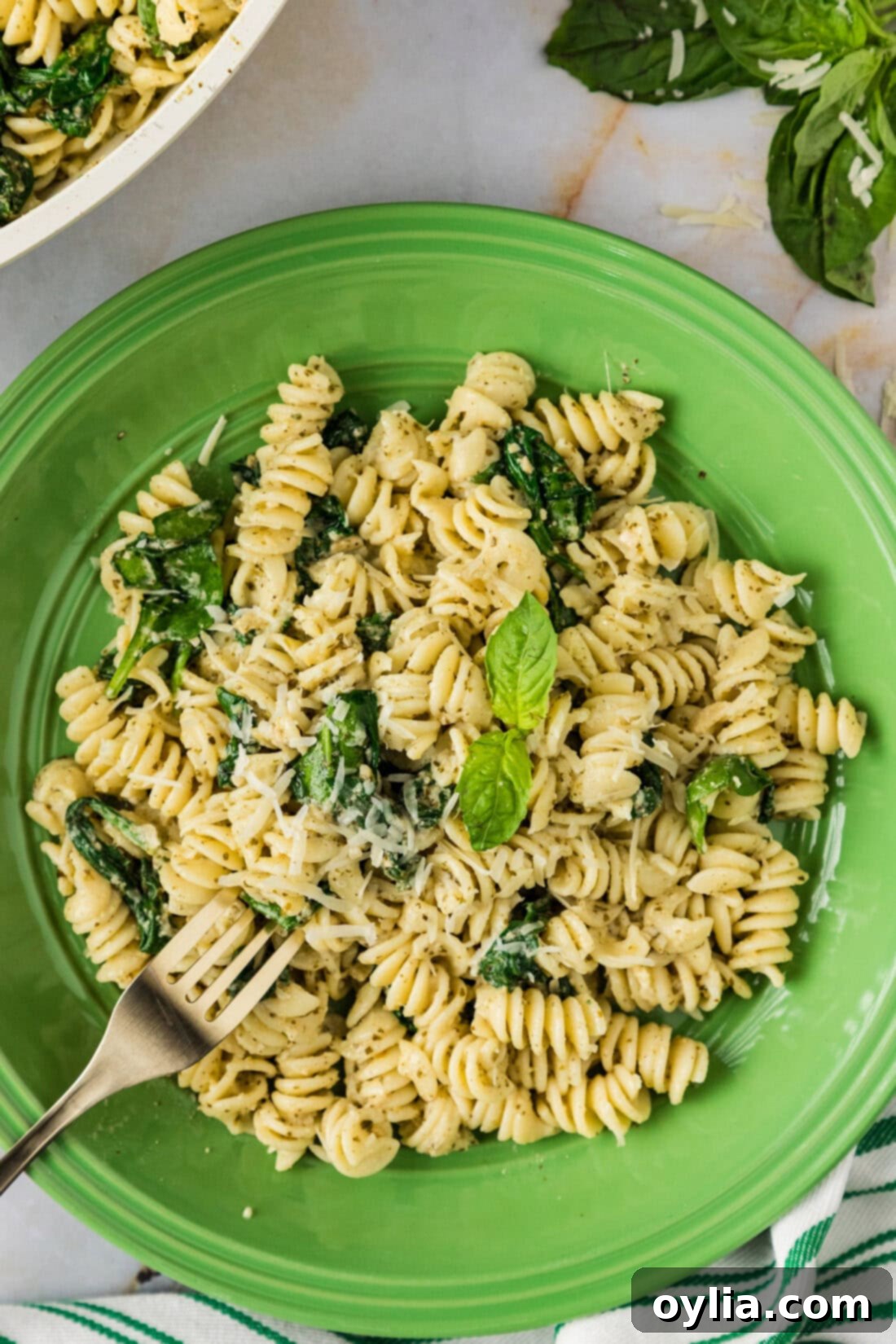 Fresh Pesto Pasta 2 Plate of Pesto Pasta with a fork in it, showcasing its fresh, creamy texture and vibrant green pesto