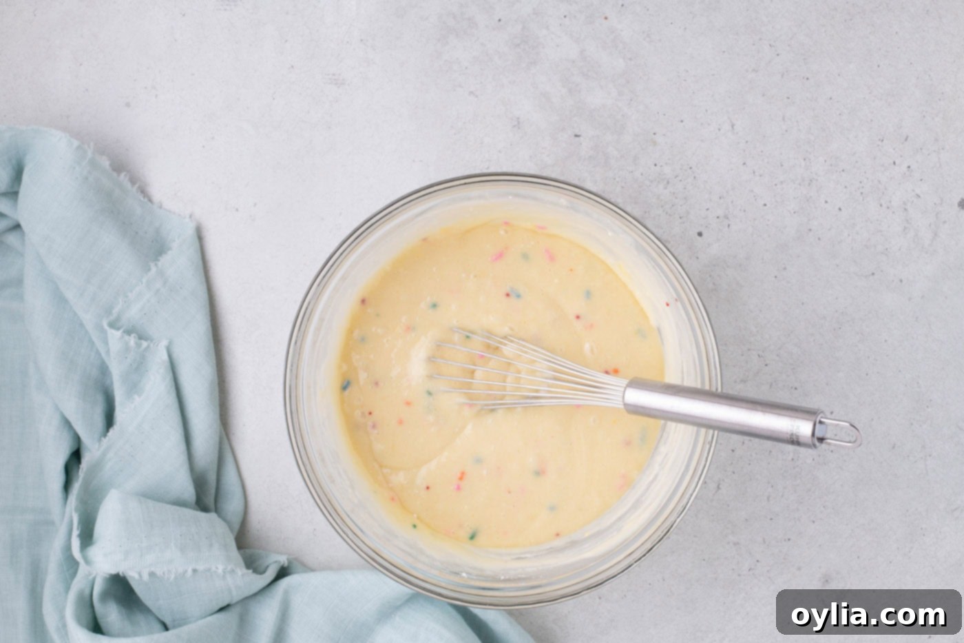 cake mix ingredients in a bowl being whisked together