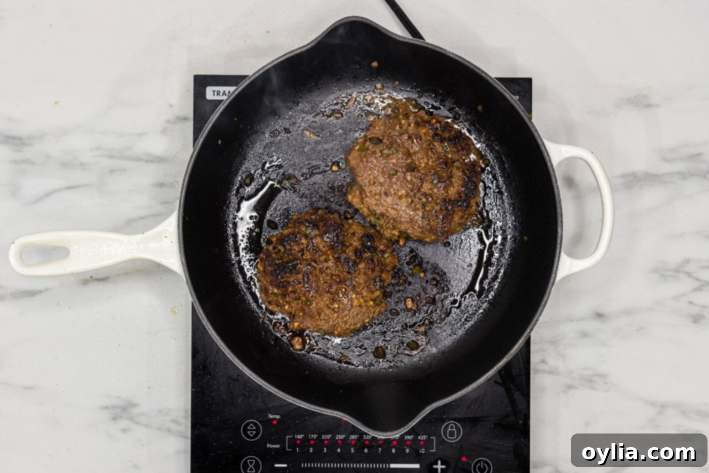 cooked taco burger patties in a skillet