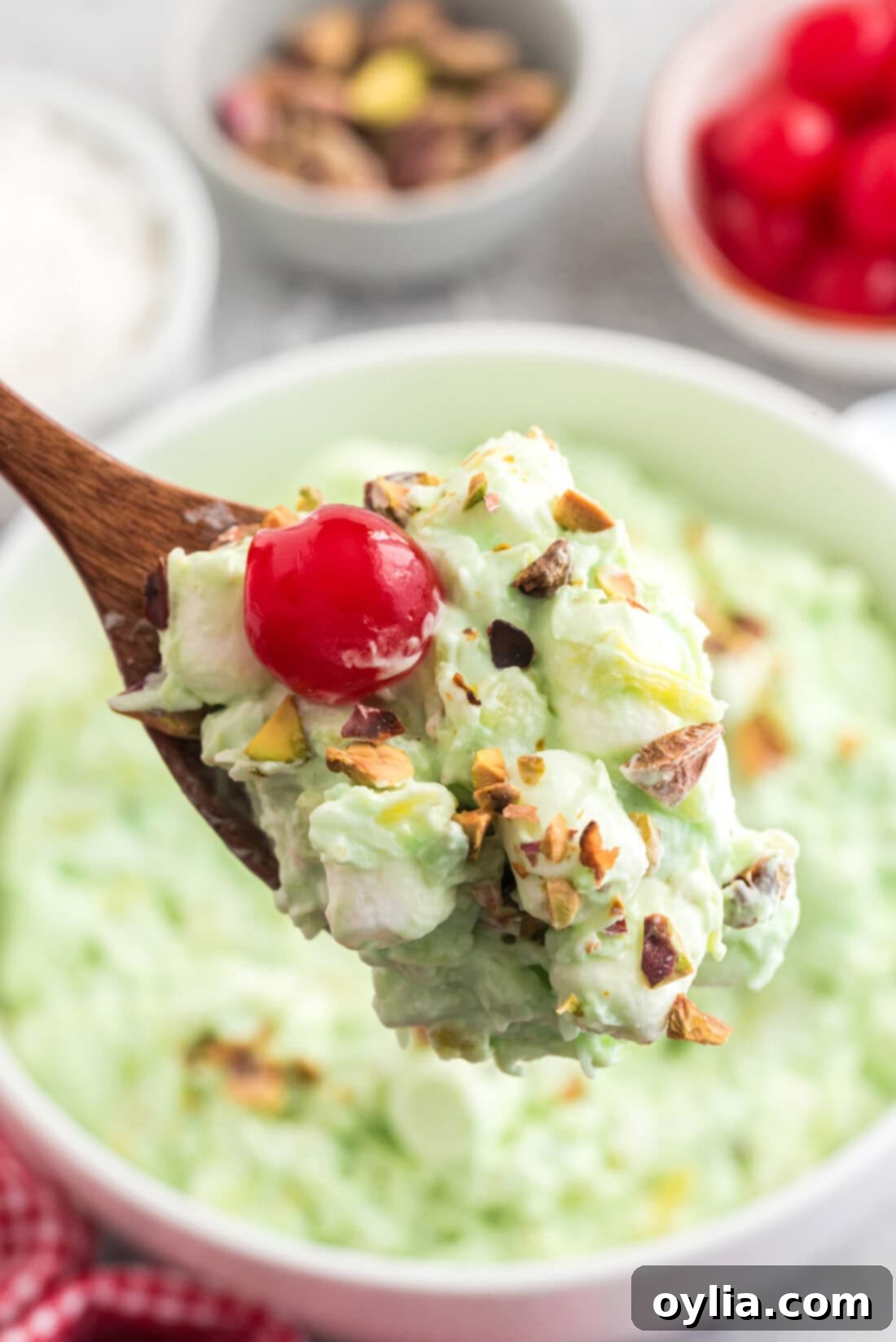 A large bowl of Watergate Salad, garnished simply with a few mini marshmallows, ready to be served.