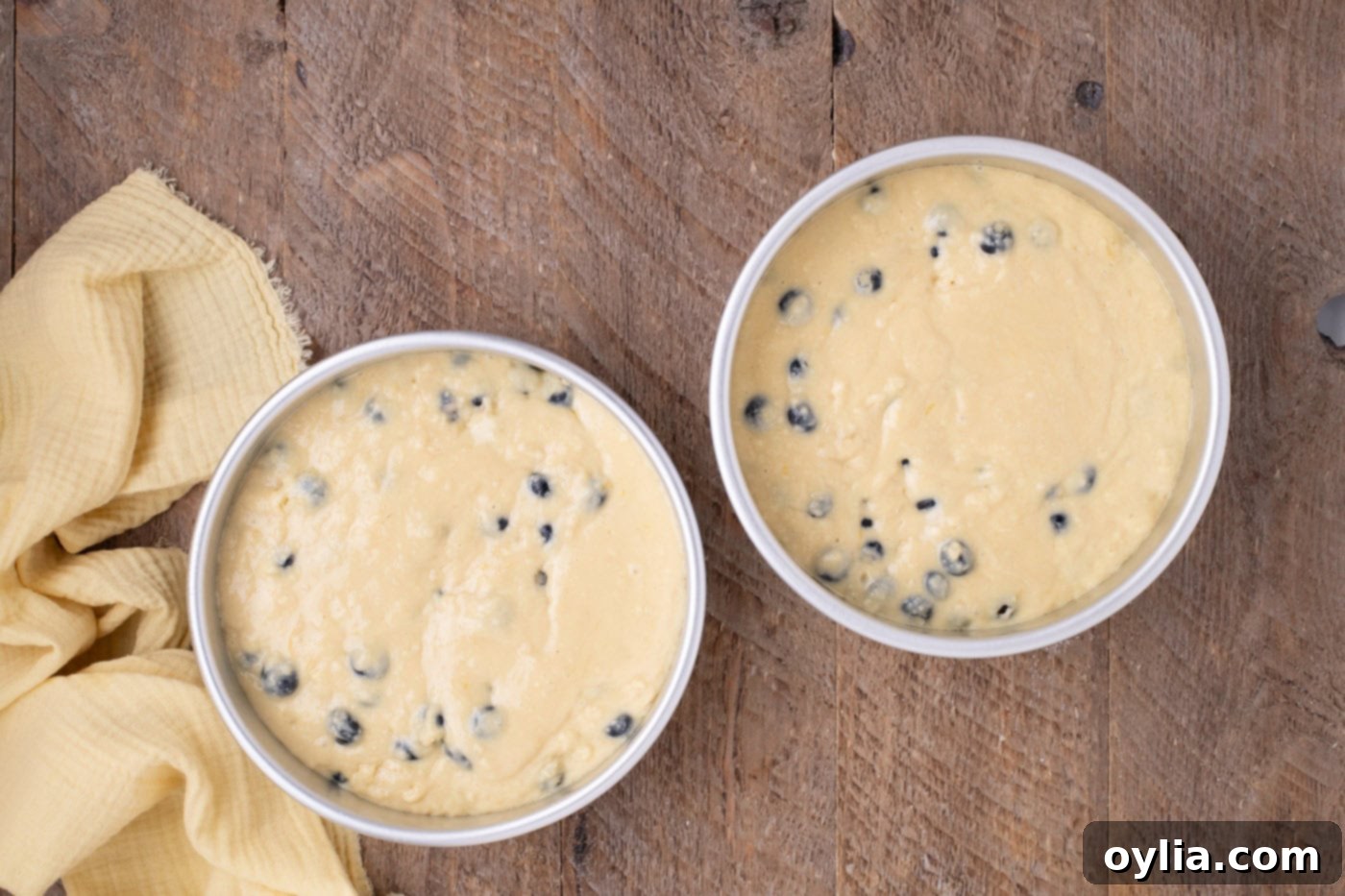 lemon blueberry cake batter in baking pans