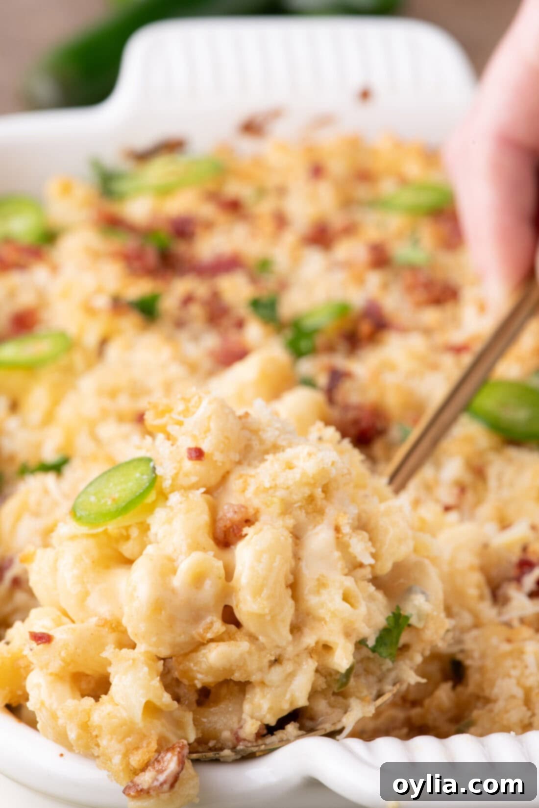 Spoon lifting out a serving of Jalapeno Popper Mac and Cheese