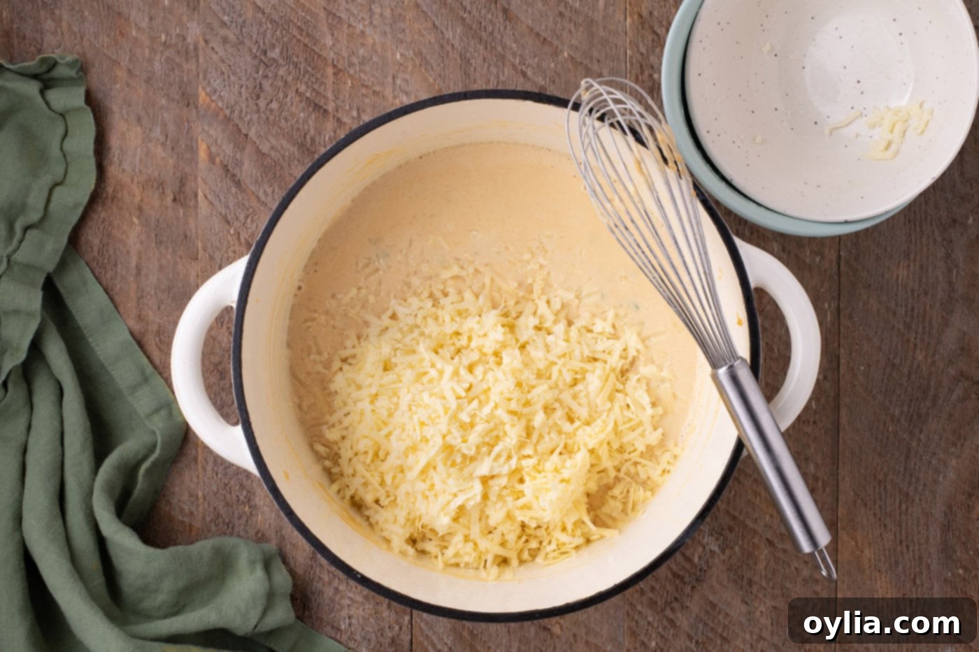 cheese added to jalapeno mixture in a pot