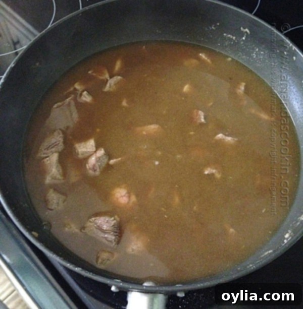 Beef Stew Biscuit Pot Pie - Step 2: Beef stew meat browning in a skillet with olive oil.