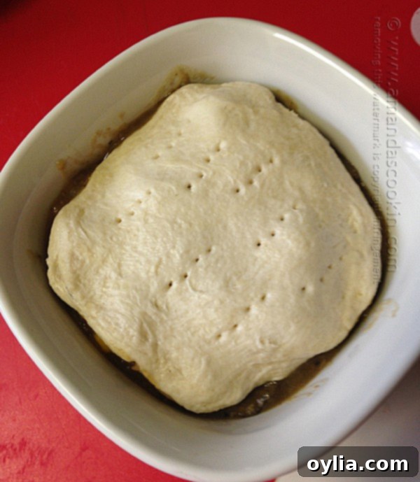 Beef Stew Biscuit Pot Pie - Step 5: Individual beef stew pot pies with biscuit toppings, ready for the oven.