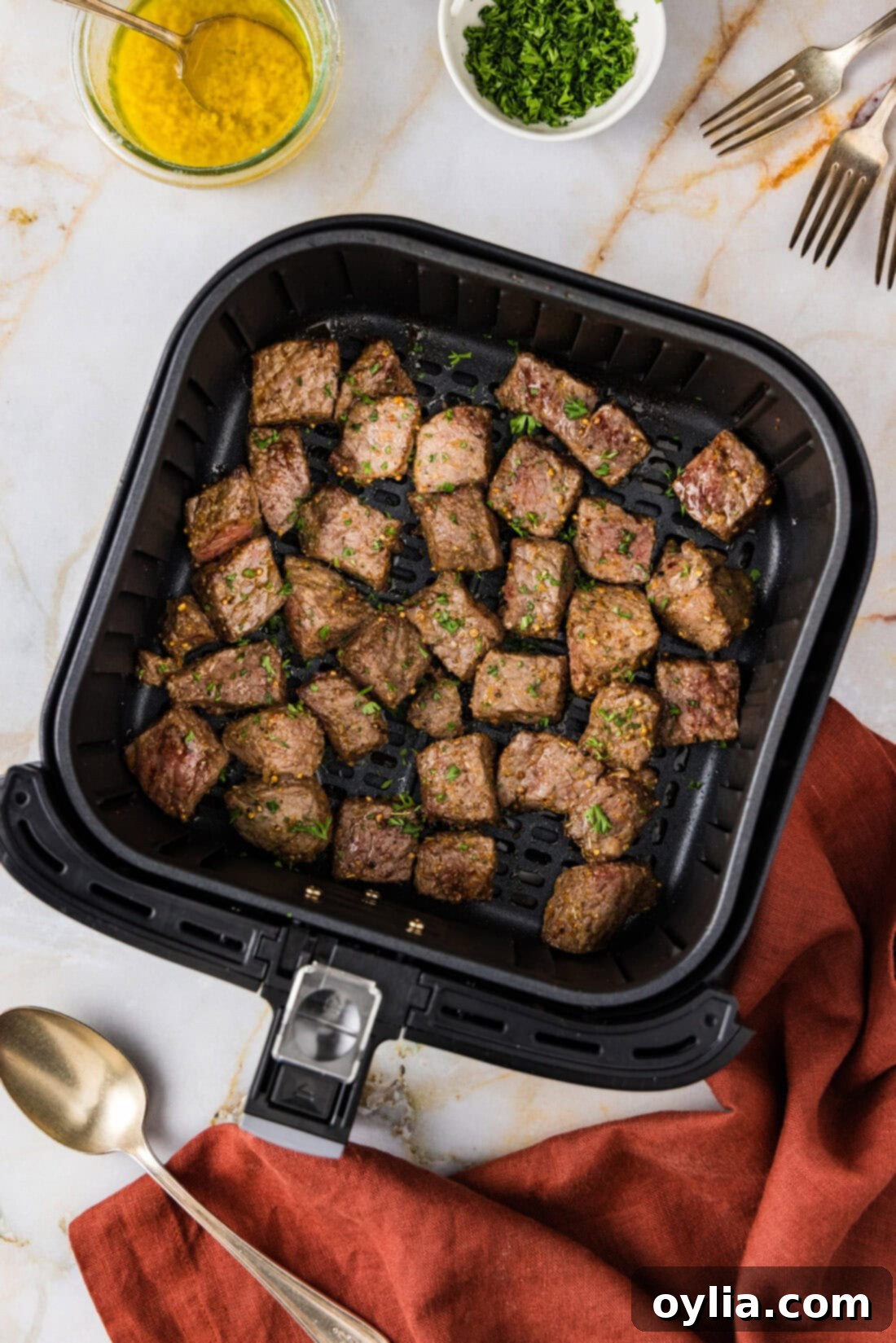 Your New Favorite Air Fryer Steak Bites 7 Perfectly cooked Air Fryer Steak Bites, golden brown and juicy, nestled in an air fryer basket.