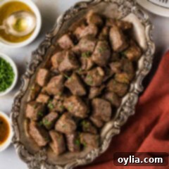 Your New Favorite Air Fryer Steak Bites 8 Close up photo of a platter of Air Fryer Steak Bites garnished with fresh herbs, ready to serve.