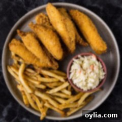 Fried Perch on a plate with fries and coleslaw