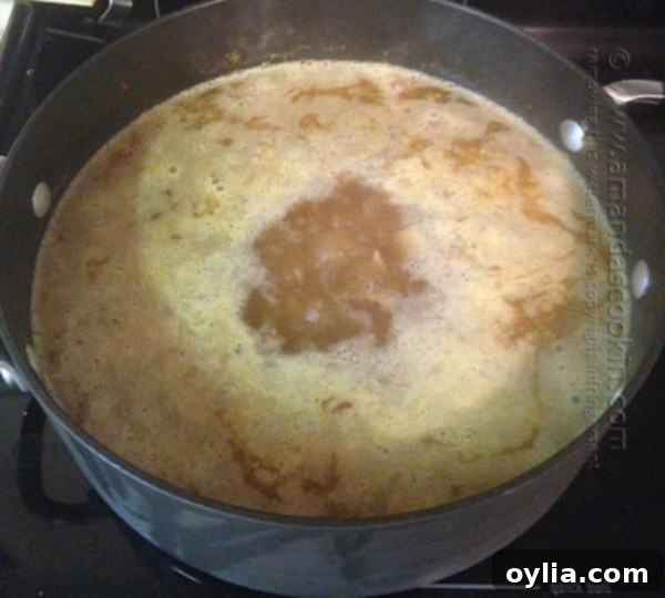 Zuppa Toscana soup simmering on low heat for 15 minutes until potatoes are tender