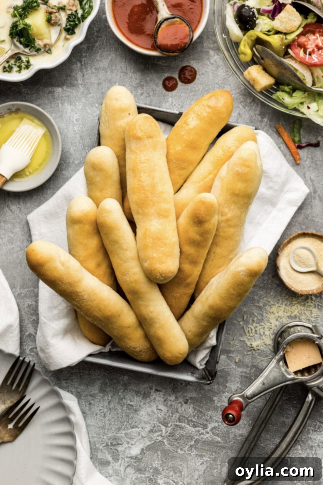 Basket of Olive Garden Breadsticks with soup and salad on the side