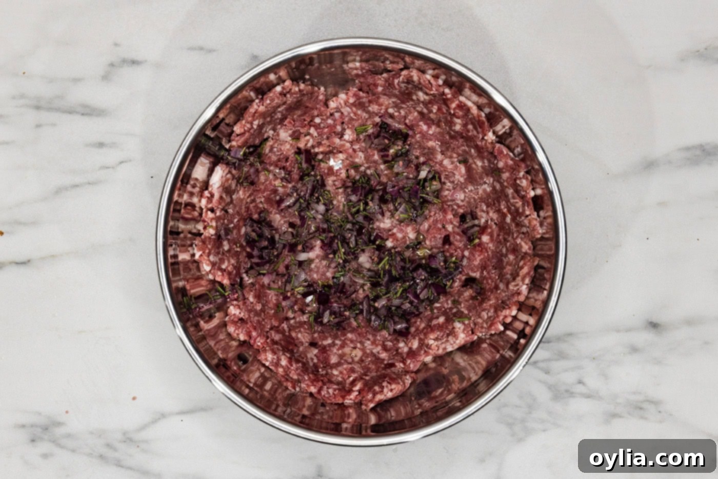 ground lamb with seasonings in a bowl