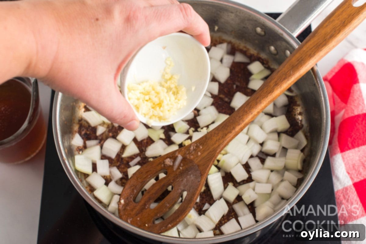 adding garlic to pan