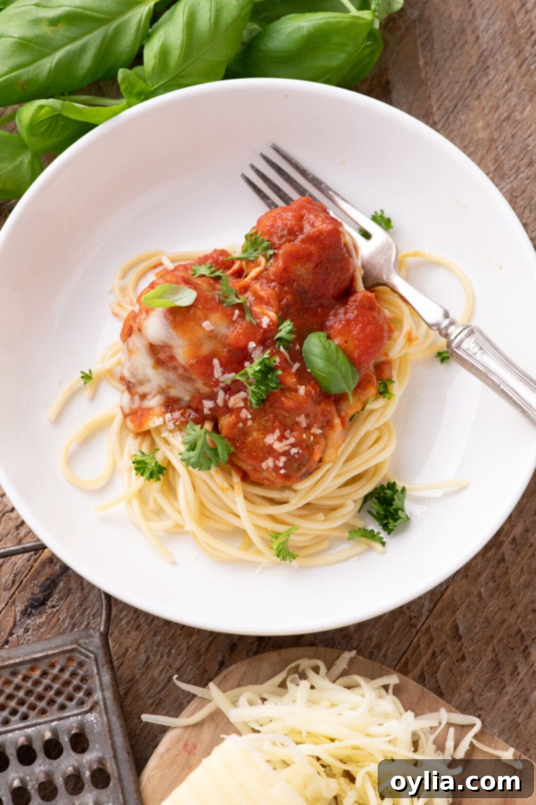 Cheesy Chicken Parm Meatballs 11 Chicken Parmesan Meatballs plated over spaghetti