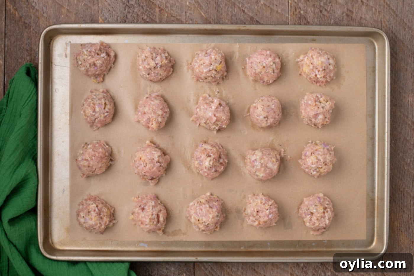 chicken meatballs on parchment lined baking shet