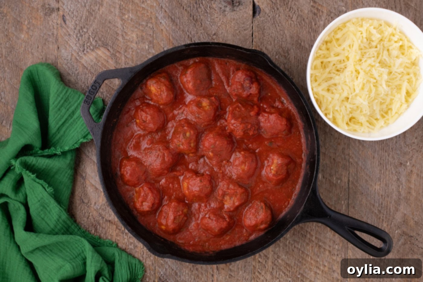 chicken meatballs in a skillet covered in marinara sauce
