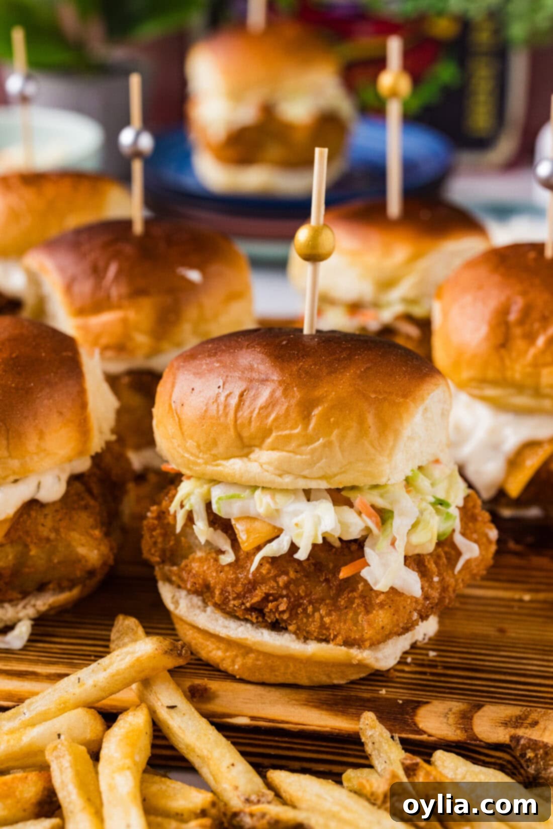 Close up photo of a Fish Slider on a wooden platter with french fries