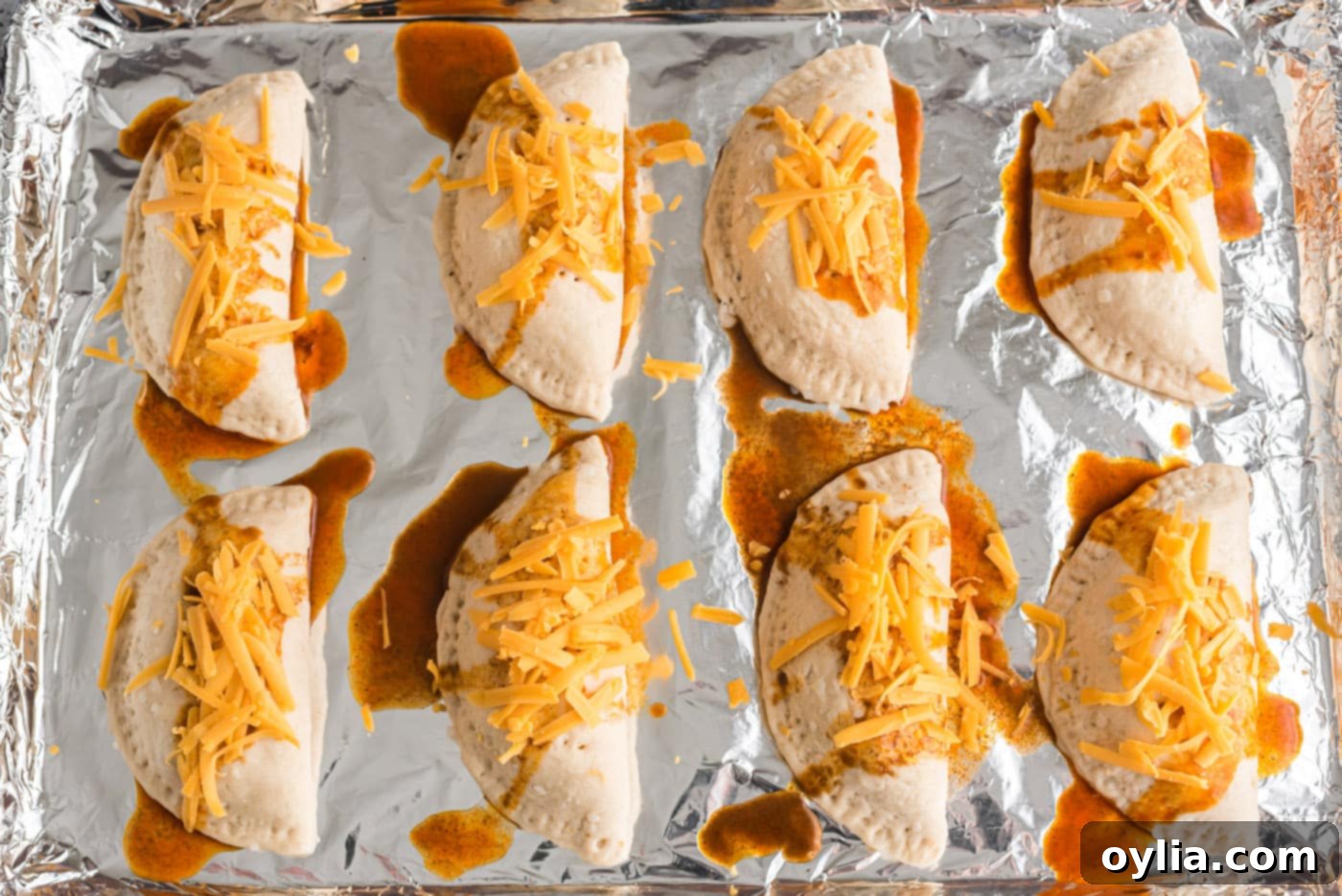 cheese on top of taco empanadas before baking