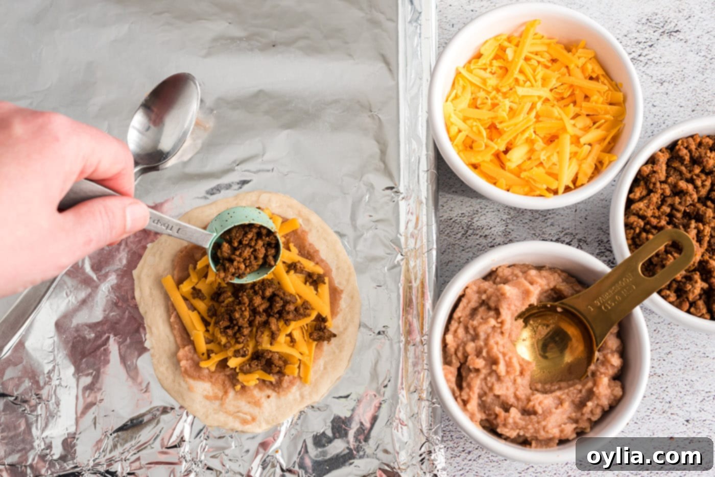 adding taco meat to empanadas filling