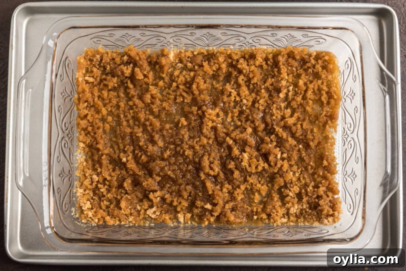 A smooth, even layer of brown sugar and melted butter at the bottom of a baking dish