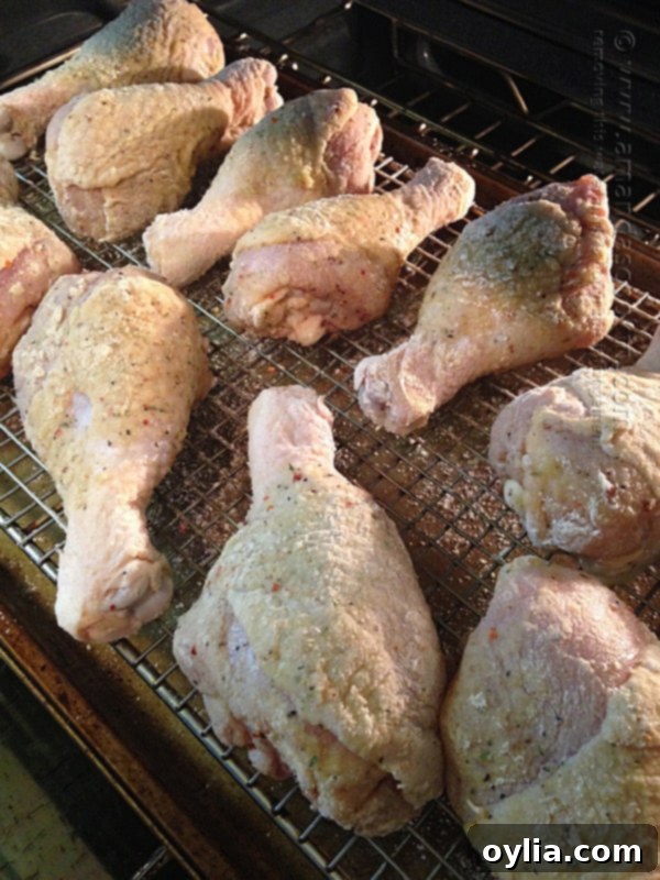 Brushing chicken with olive oil and coating in flour mixture.