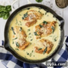 Close up photo of a skillet of Chicken Florentine, showing the creamy sauce and chicken
