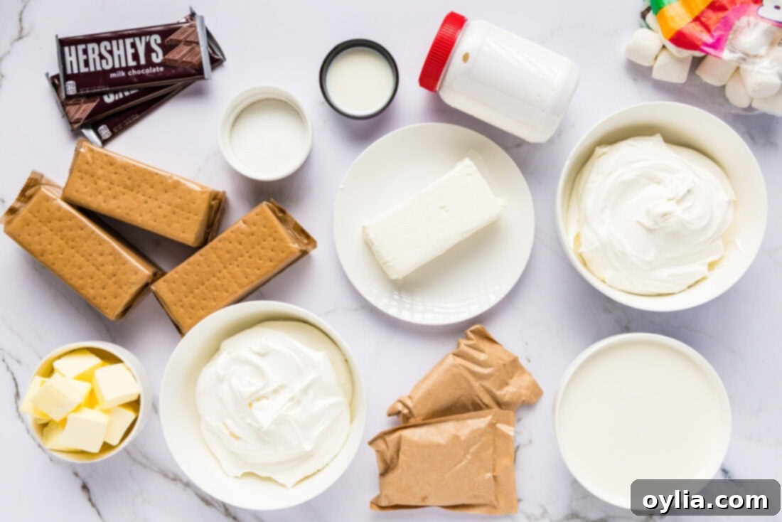 Ultimate S'mores Lasagna 4 Ingredients laid out for S'mores Lasagna, including graham crackers, chocolate bars, marshmallow fluff, and pudding mixes