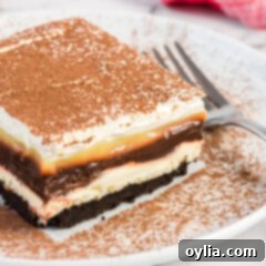 Close up photo of a slice of Sex in a Pan on a plate, showing all the dessert layers