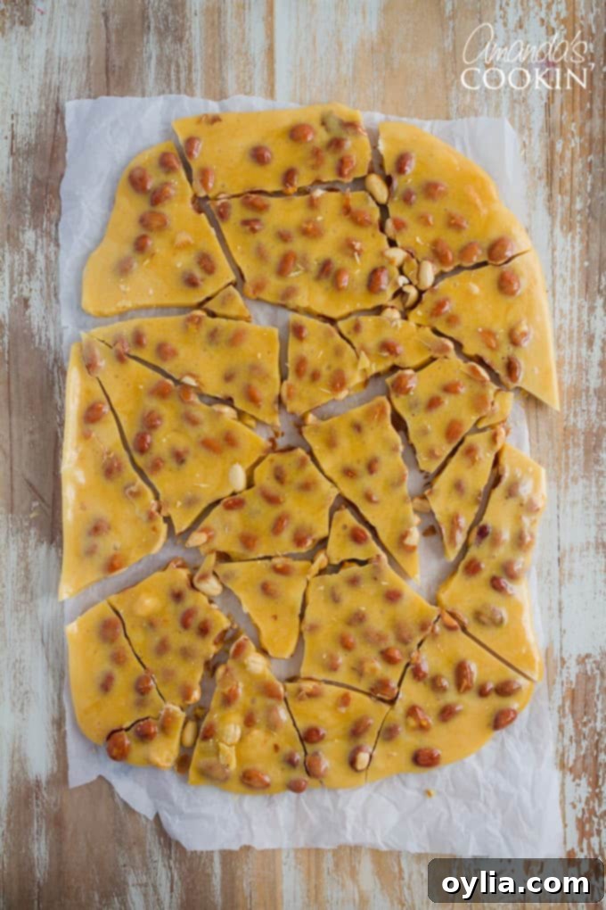 Delicious Homemade Peanut Brittle cooling on a tray, ready to be broken into pieces