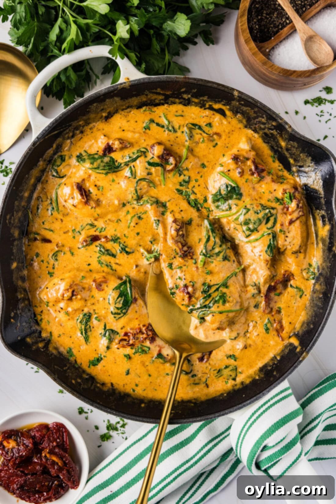 Creamy Tuscan Chicken 2 Skillet of Tuscan Chicken with a spatula in it