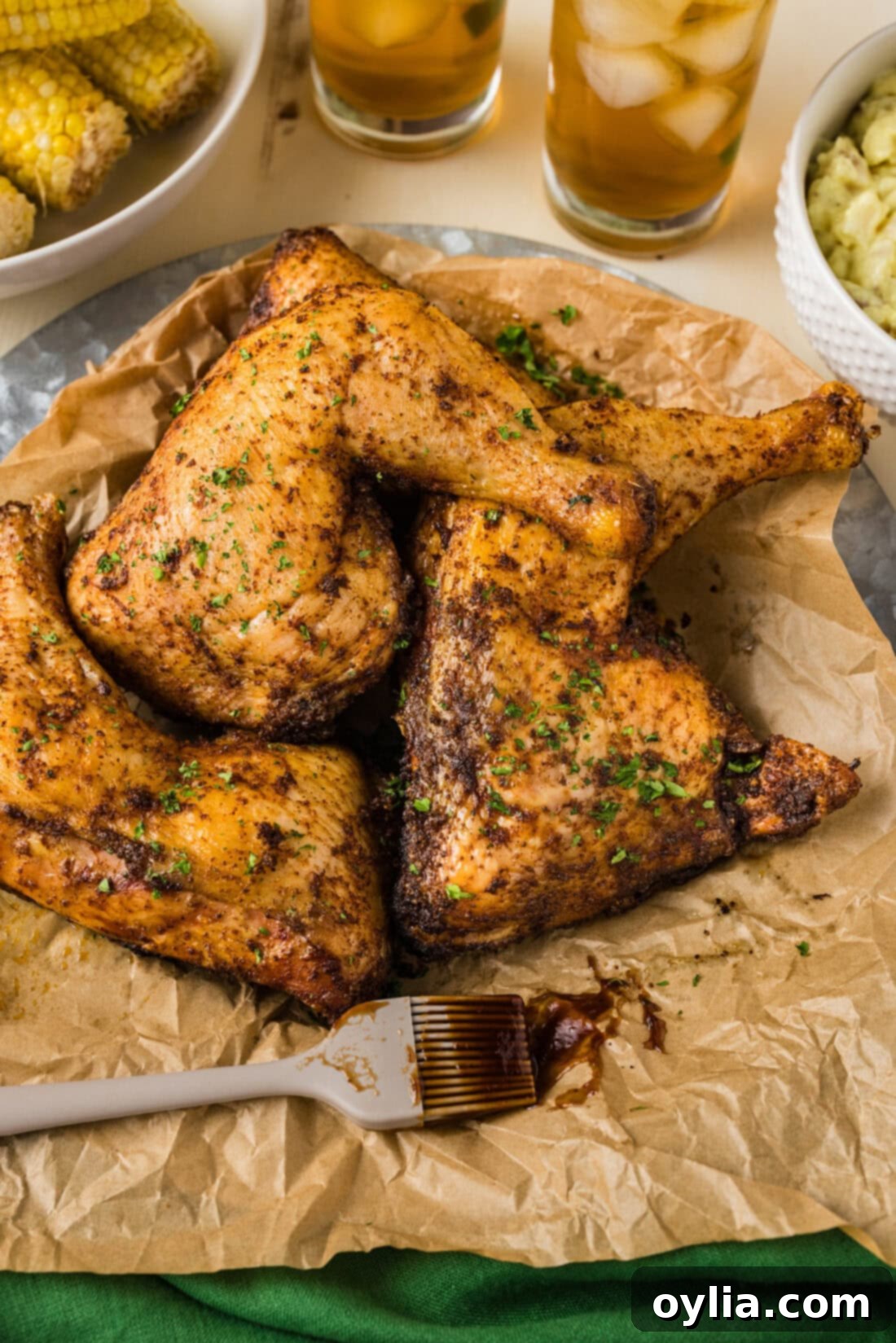 Perfectly Smoked Chicken Quarters 2 Smoked Chicken Quarters on a parchment lined platter