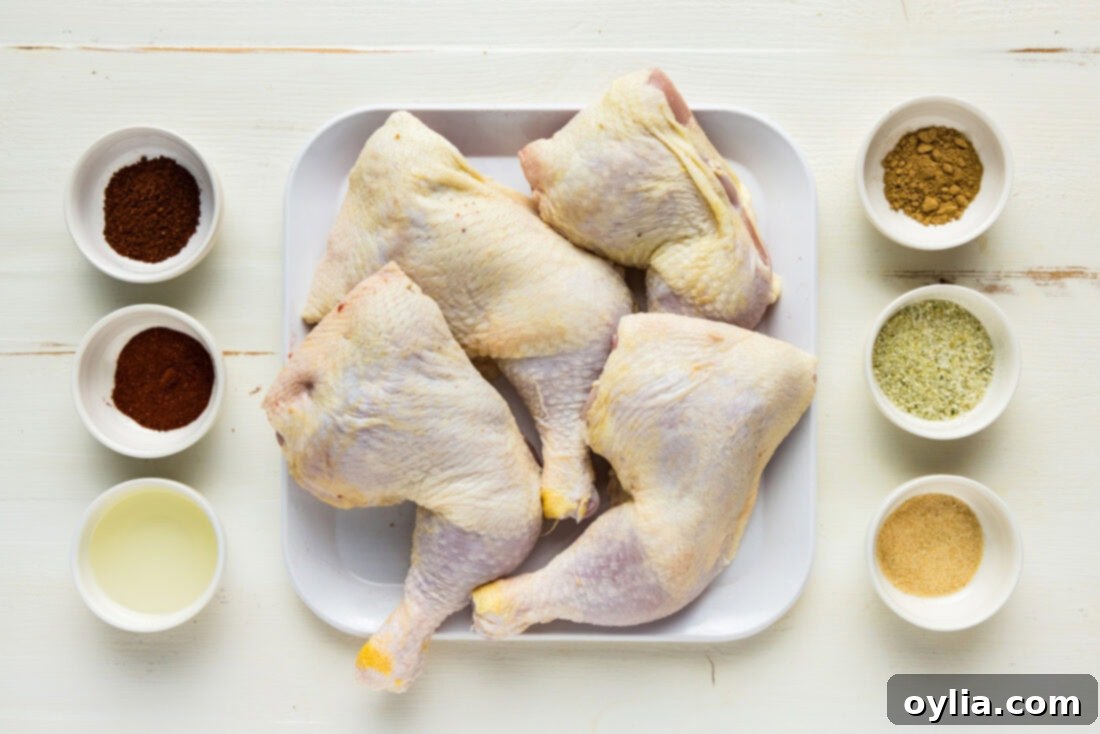 Perfectly Smoked Chicken Quarters 4 Ingredients for Smoked Chicken Quarters, including chicken, various spices, and olive oil, laid out on a white surface.
