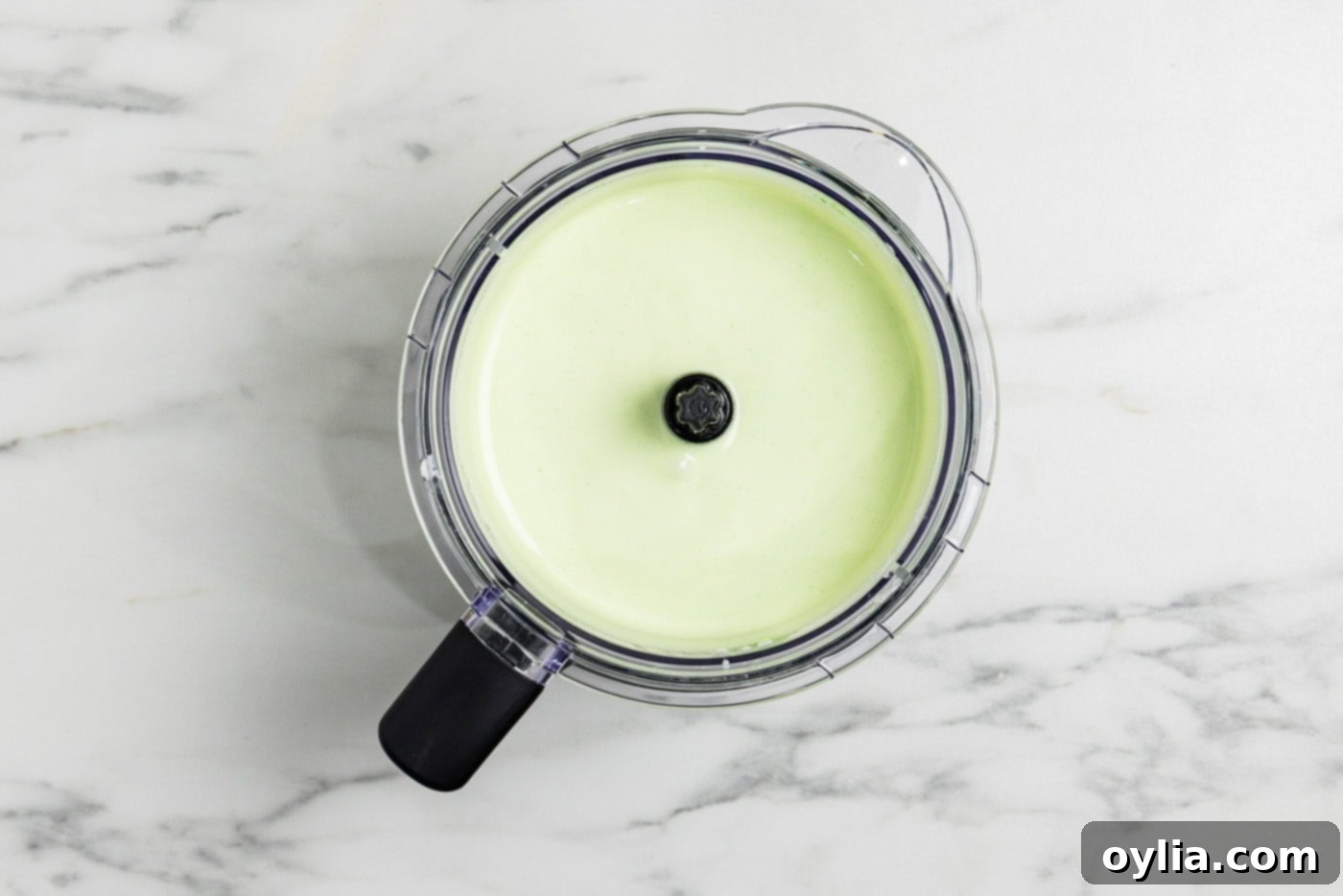 Photo of the perfectly blended keto cheesecake mixture in a food processor, smooth and ready.