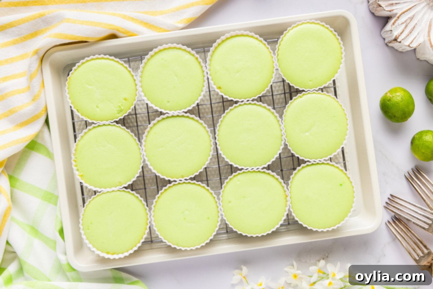 Overhead photo of freshly baked keto lime cheesecakes, golden and puffed.